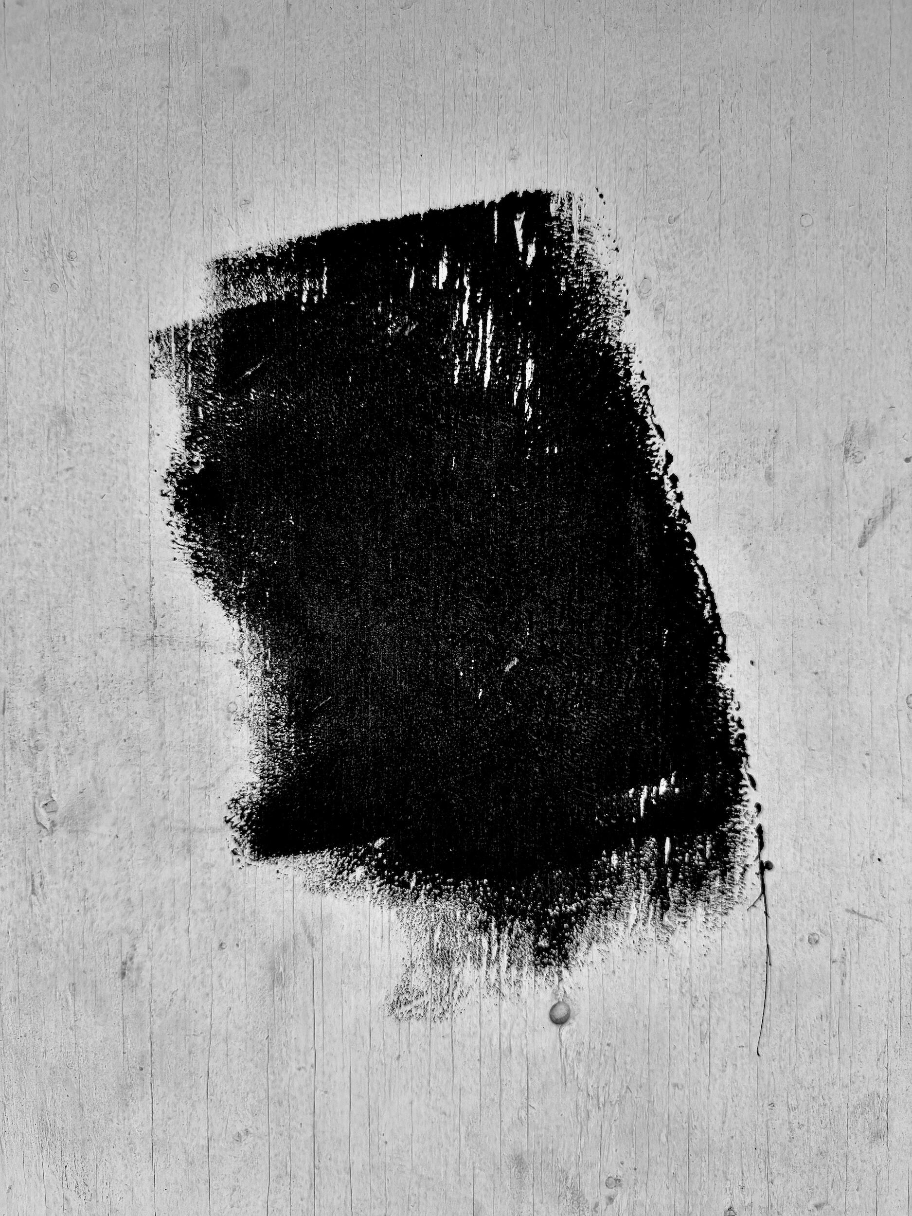 queen queen - glyph | LA - A high-contrast industrial noir photograph of paint strokes on a weathered urban wall. Fine art black-and-white photography, Los Angeles, California. 1/1 archival pigment print by Barton Caplan
