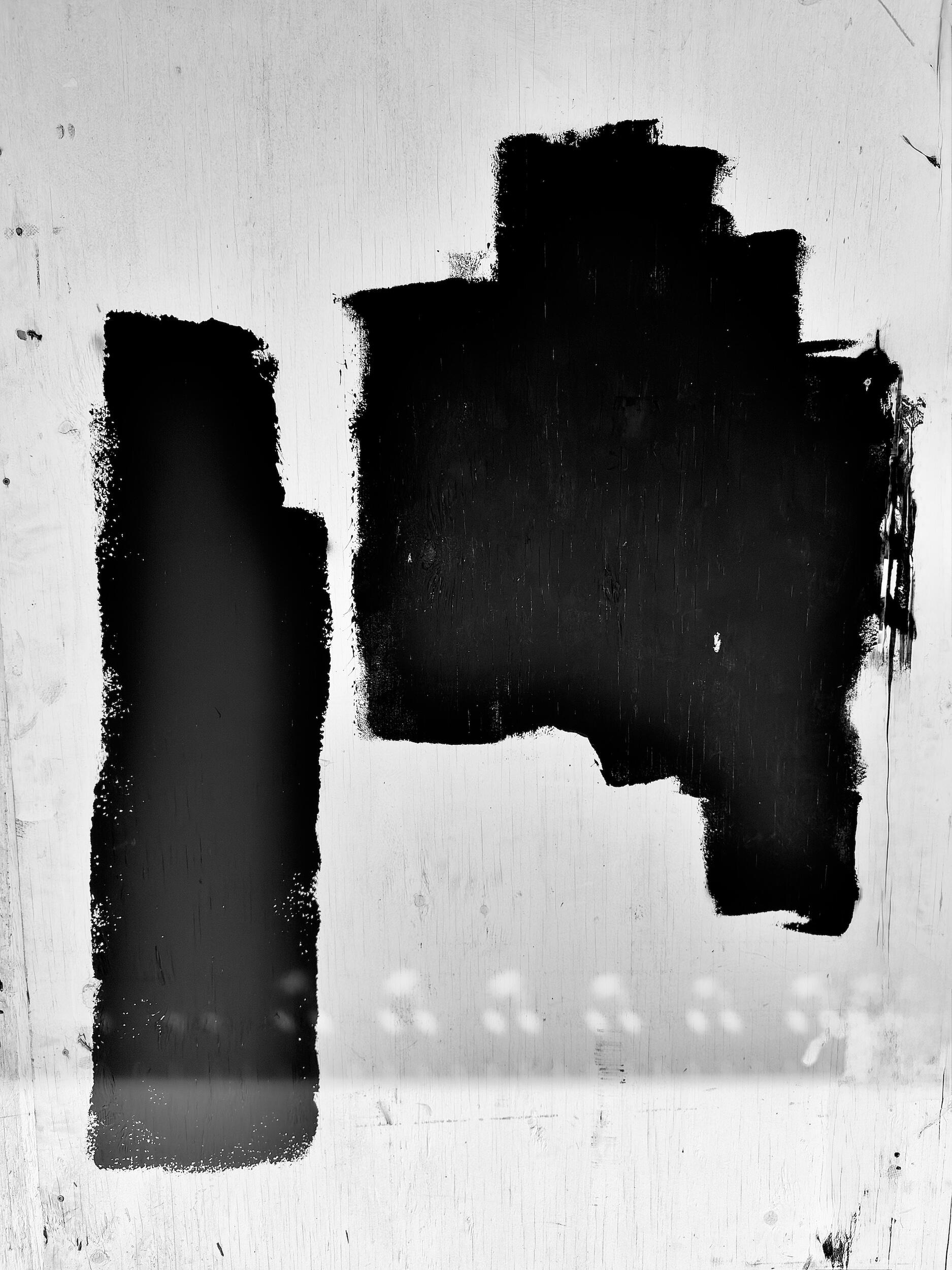 duo double - glyph | LA - Two parallel black shapes interacting on a textured wood surface. Industrial noir black-and-white photography, Los Angeles, California. 1/1 archival pigment print by Barton Caplan