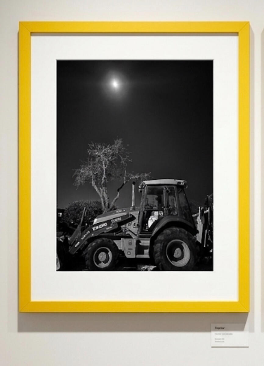 tractor & entrance at TAG Gallery The photograph shows a weathered brick wall with a rectangular sign above.